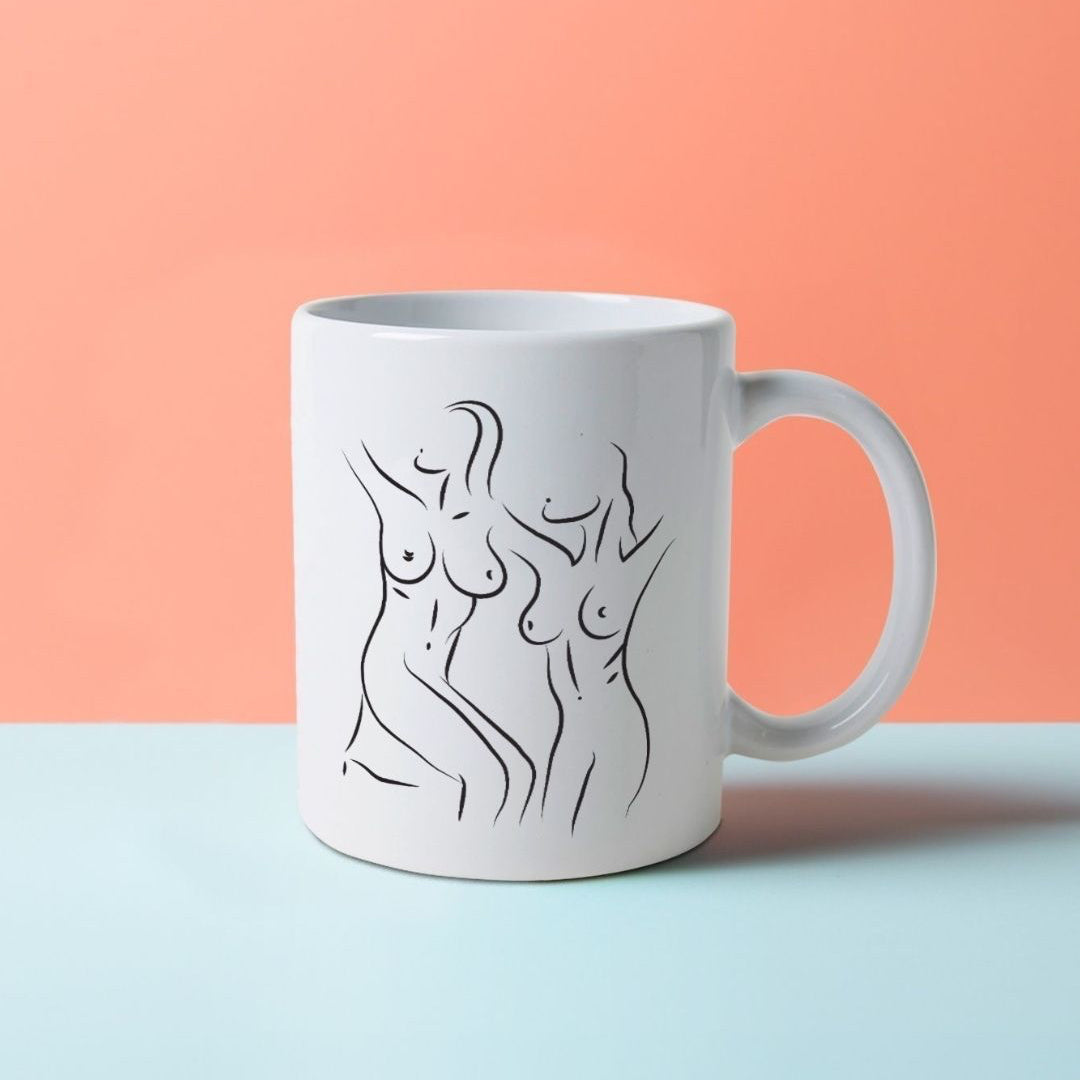 A white mug with a black line drawing of artistic, nude women's bodies.