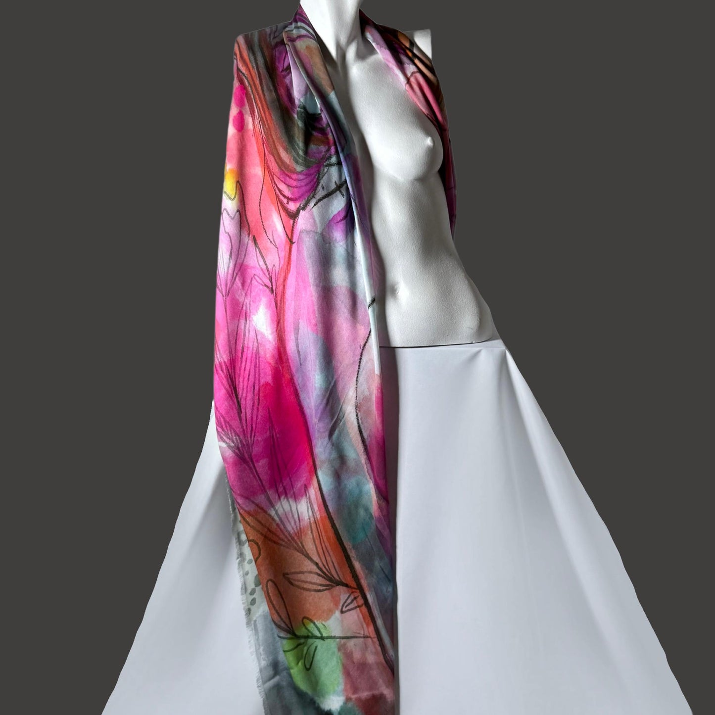 A colorful scarf with floral patterns displayed on a mannequin.