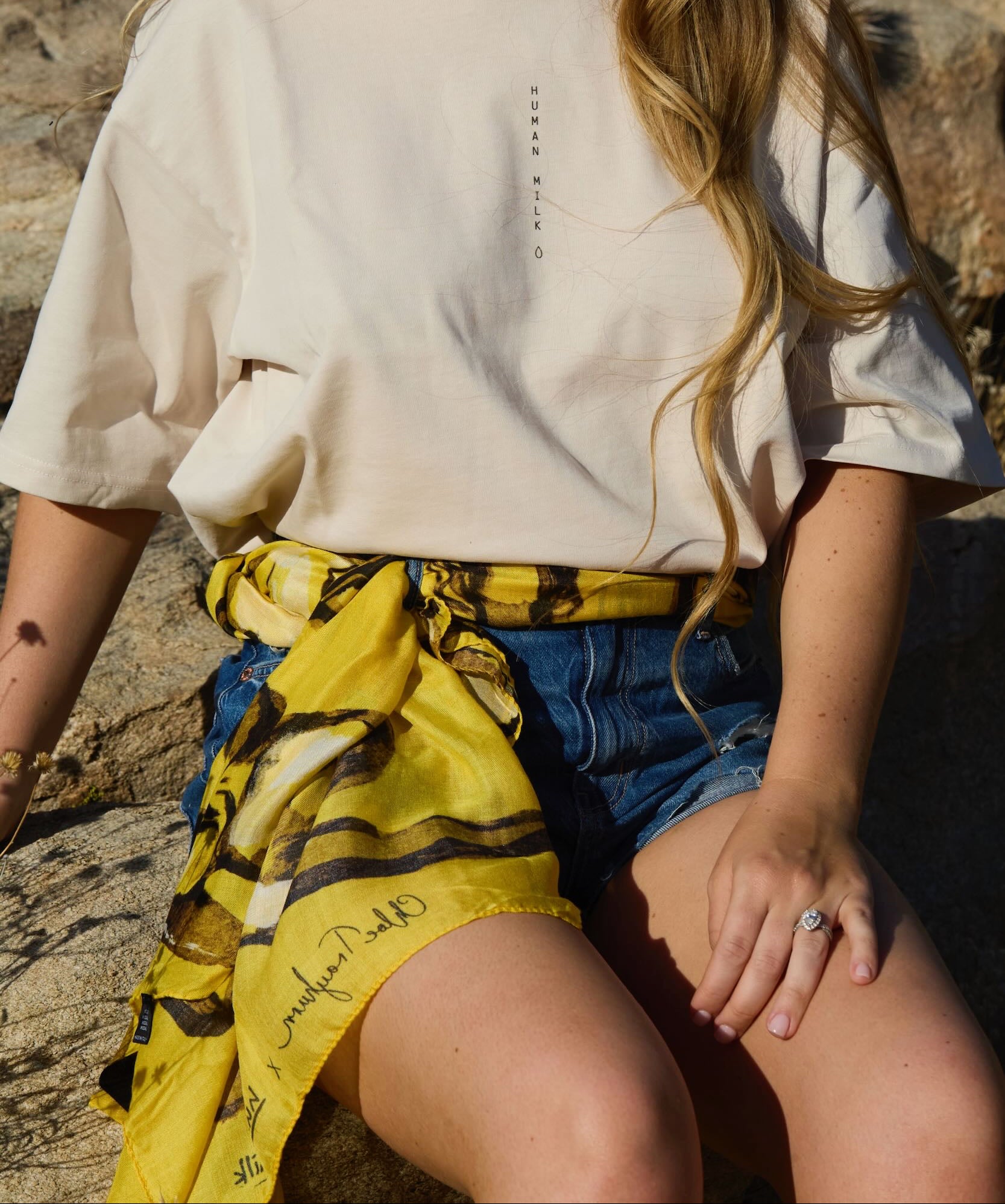 A Human Milk yellow scarf wrapped around shorts like a belt