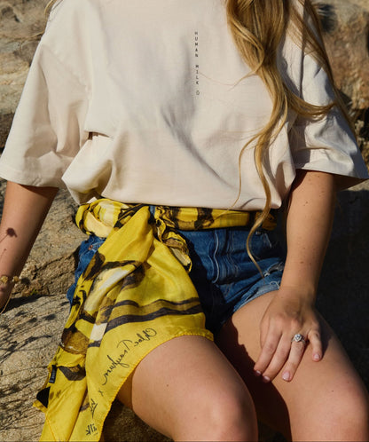 A Human Milk yellow scarf wrapped around shorts like a belt