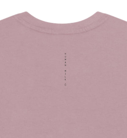 Pink long-sleeve crop top with a Human Milk logo, on a white background