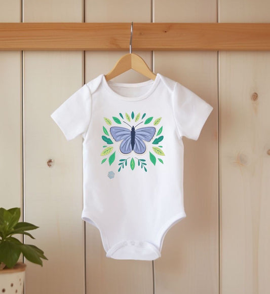 A white organic cotton bodysuit for babies and toddlers, printed with a blue butterfly and green leaves