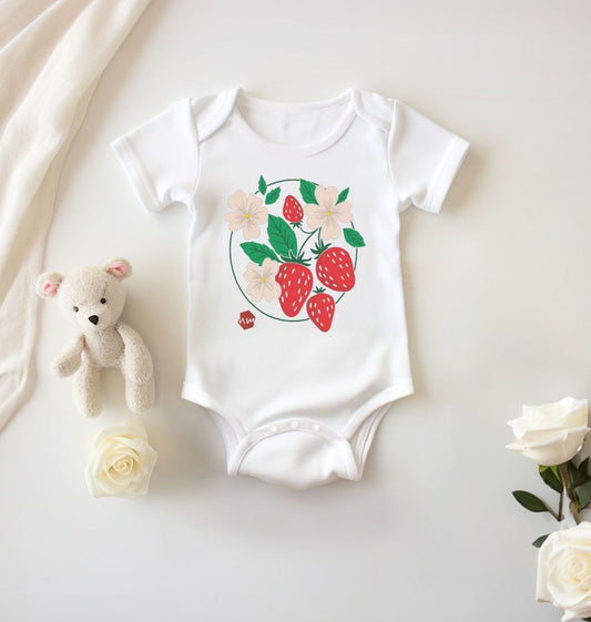 A white baby and toddler bodysuit with a print of strawberries on the front